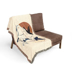 Brown chair with a decorative blanket featuring animal designs on a white background