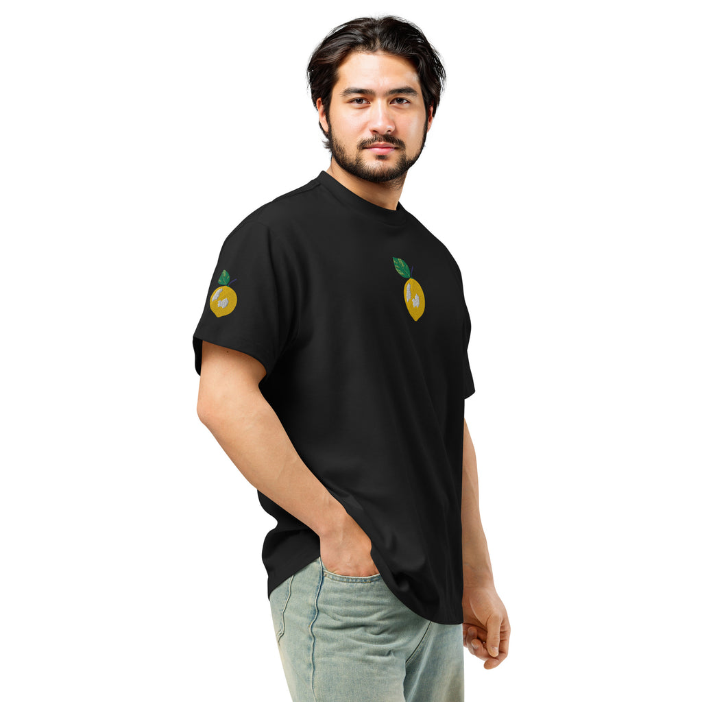 Man wearing a black t-shirt with lemon designs on a white background