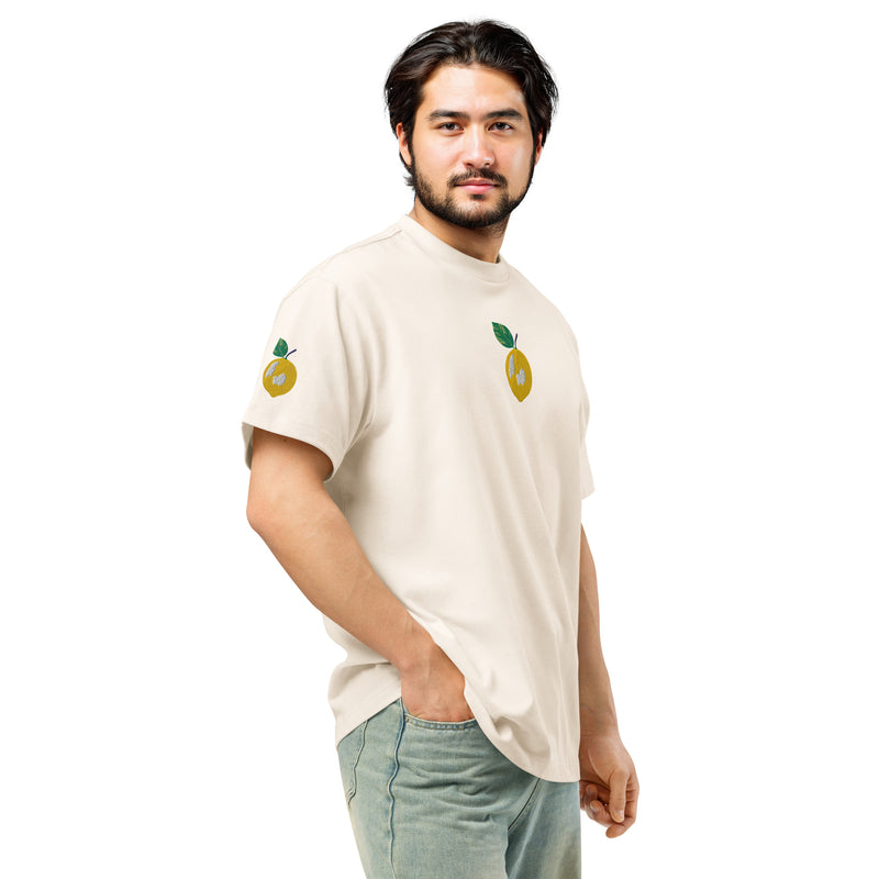 Man wearing a white t-shirt with lemon designs on a white background