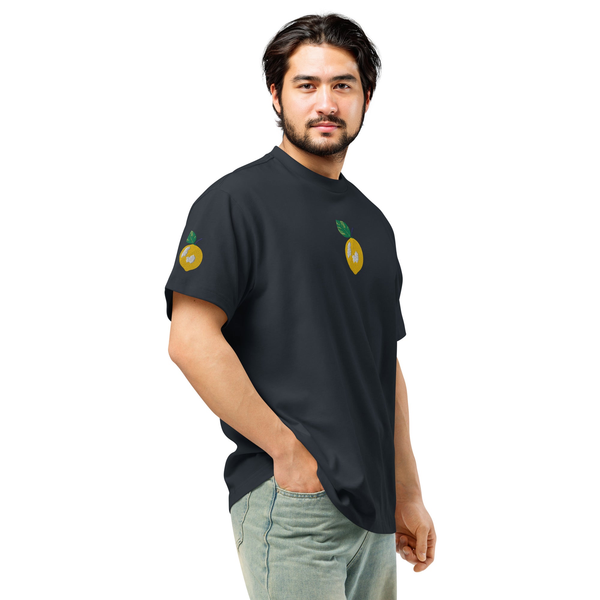 Man wearing a black t-shirt with lemon designs on a white background