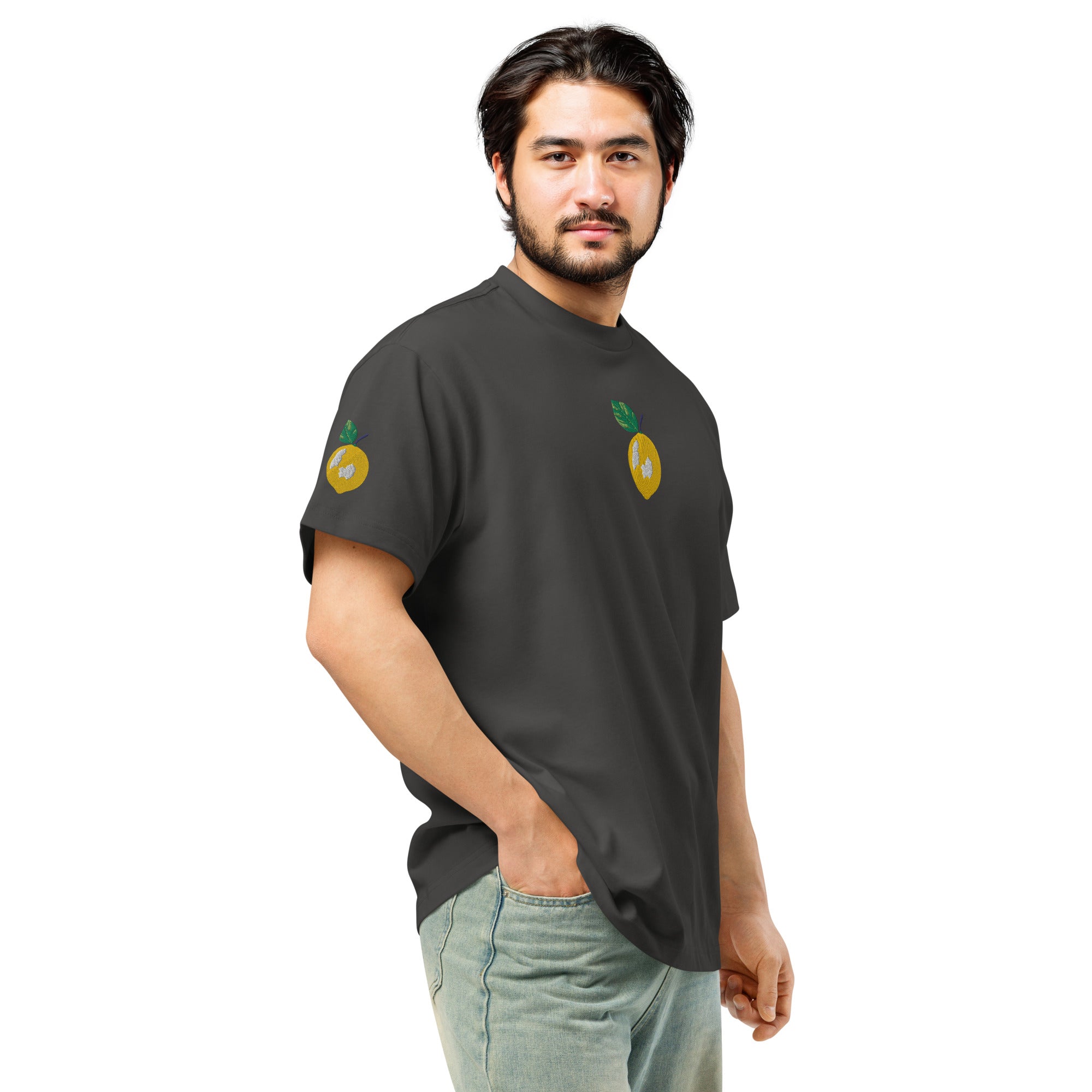 Man wearing a black t-shirt with lemon designs on a white background