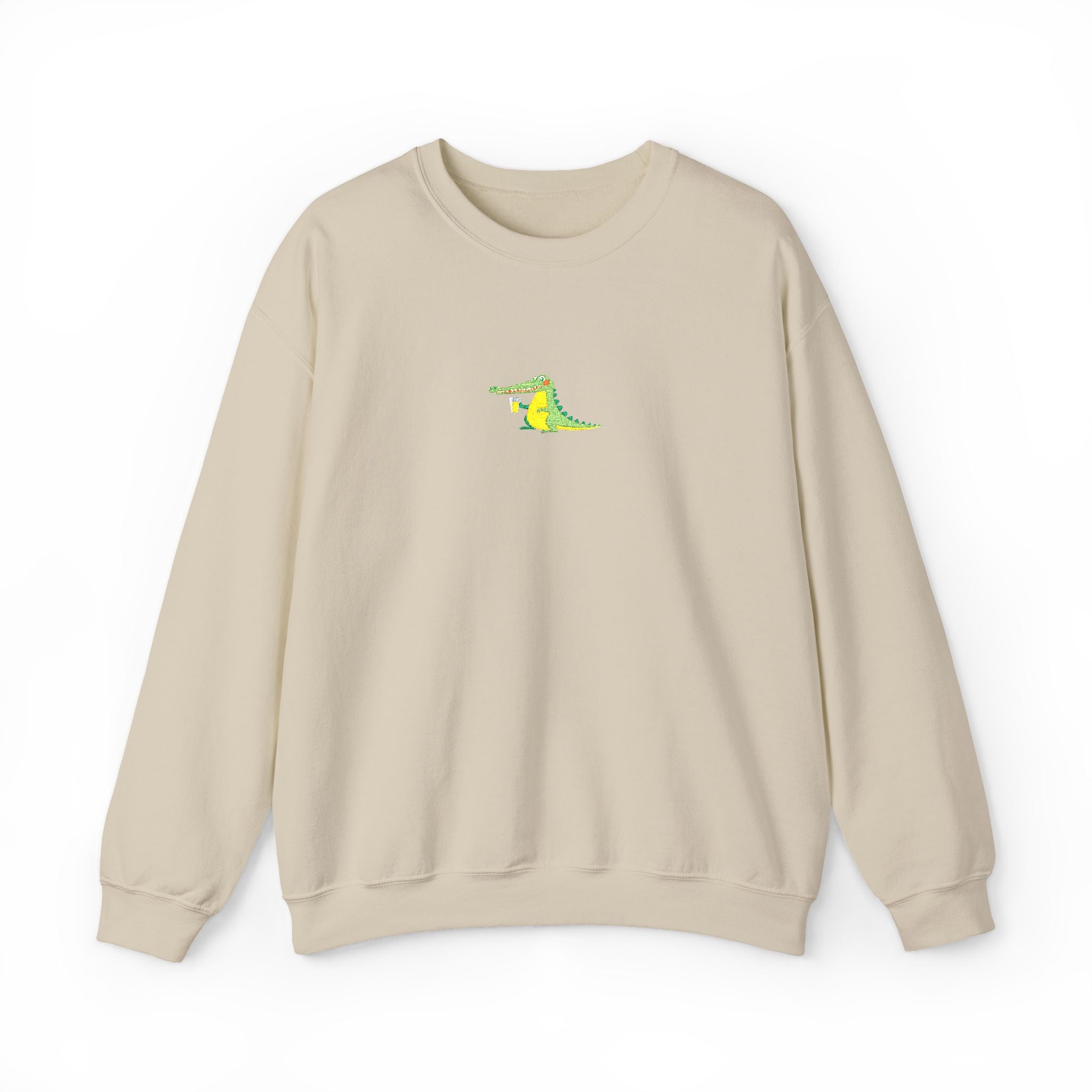 Beige sweatshirt with a small green and yellow graphic on a white background