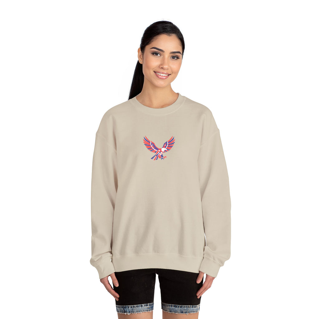 Woman wearing a beige sweatshirt with a colorful eagle design on a white background