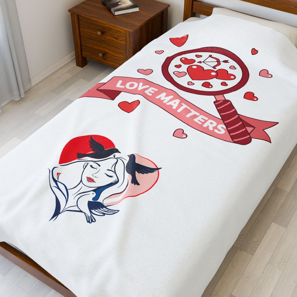 Bedspread with artistic design and 'Love Matters' text on a bed in a room.