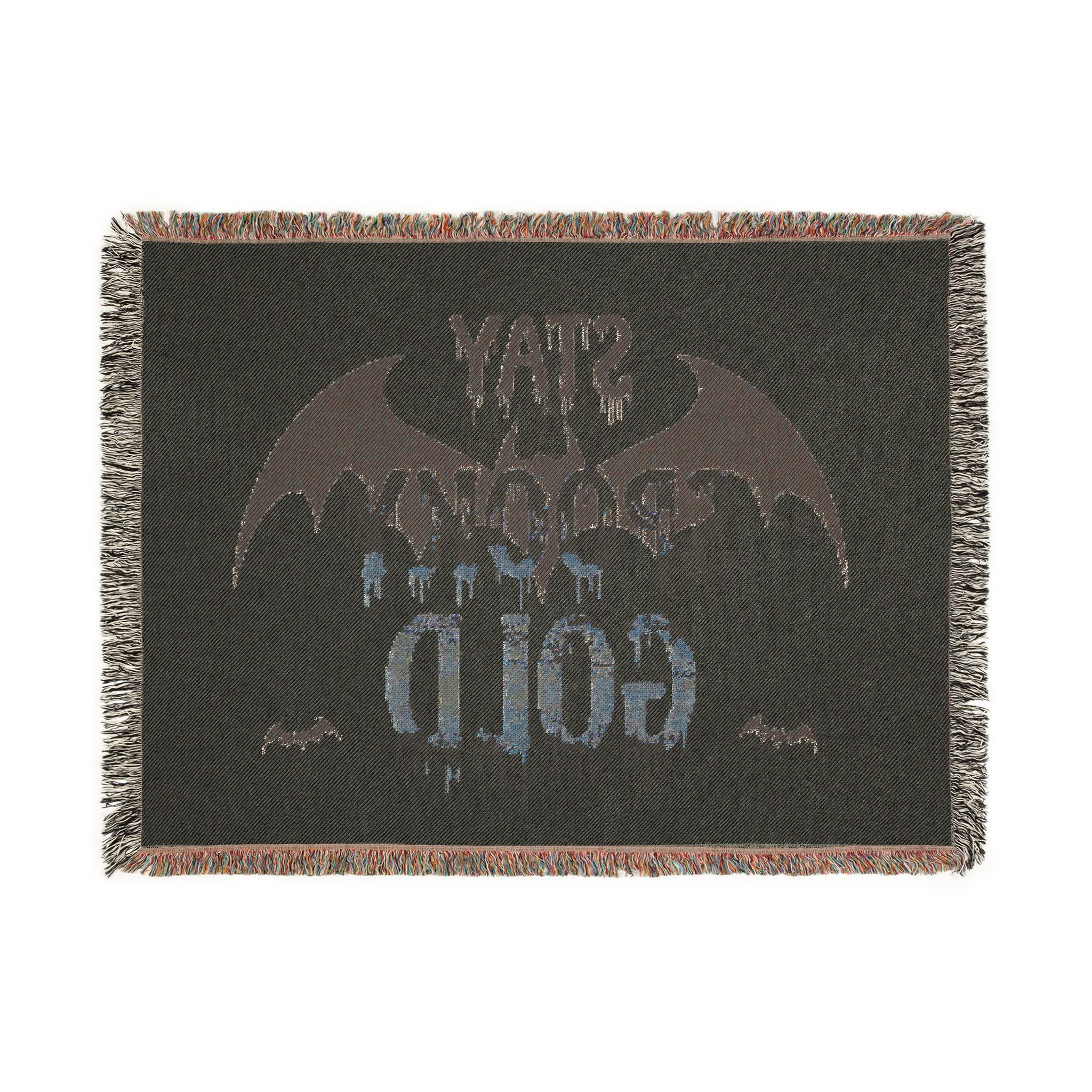 Blanket with bat design and text on a dark background