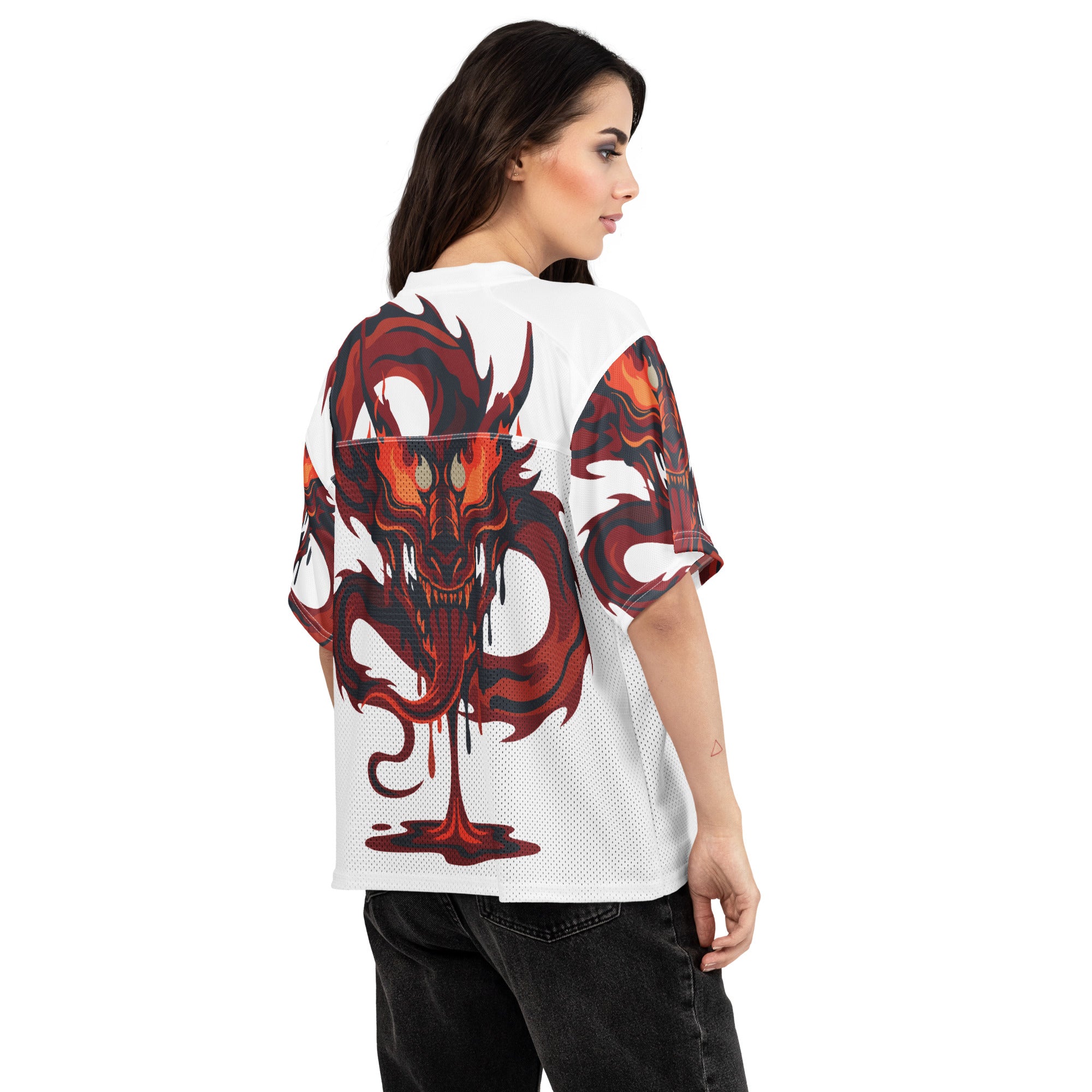 Woman wearing a white jersey with a red and black dragon design on the back.