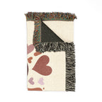 Blanket with heart pattern and fringed edge on a white background