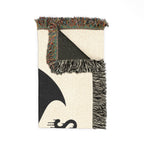 Textile with geometric pattern and fringe on a white background