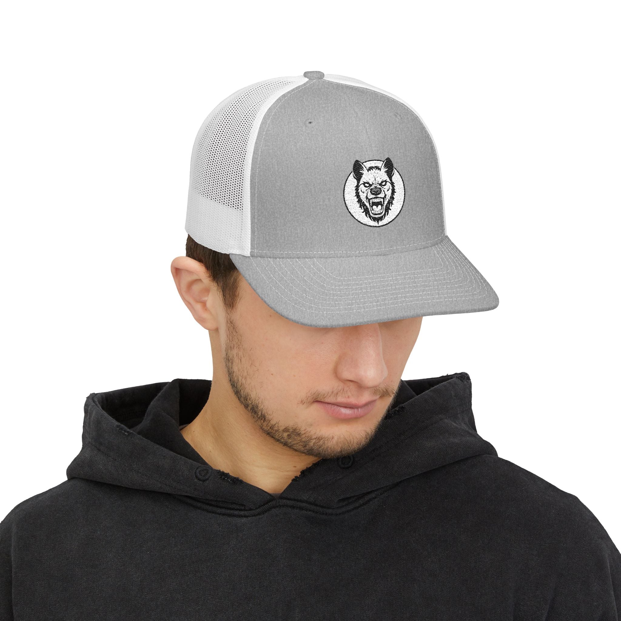 Person wearing a gray and white trucker hat with a logo on a white background