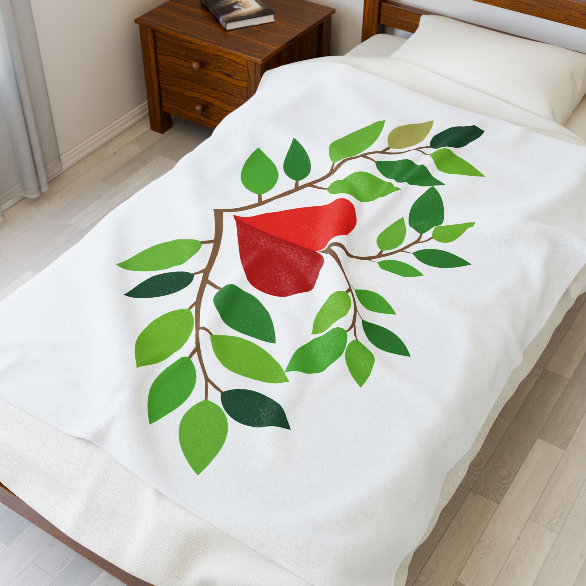 White blanket with a red bird and green leaves design on a bed in a bedroom.
