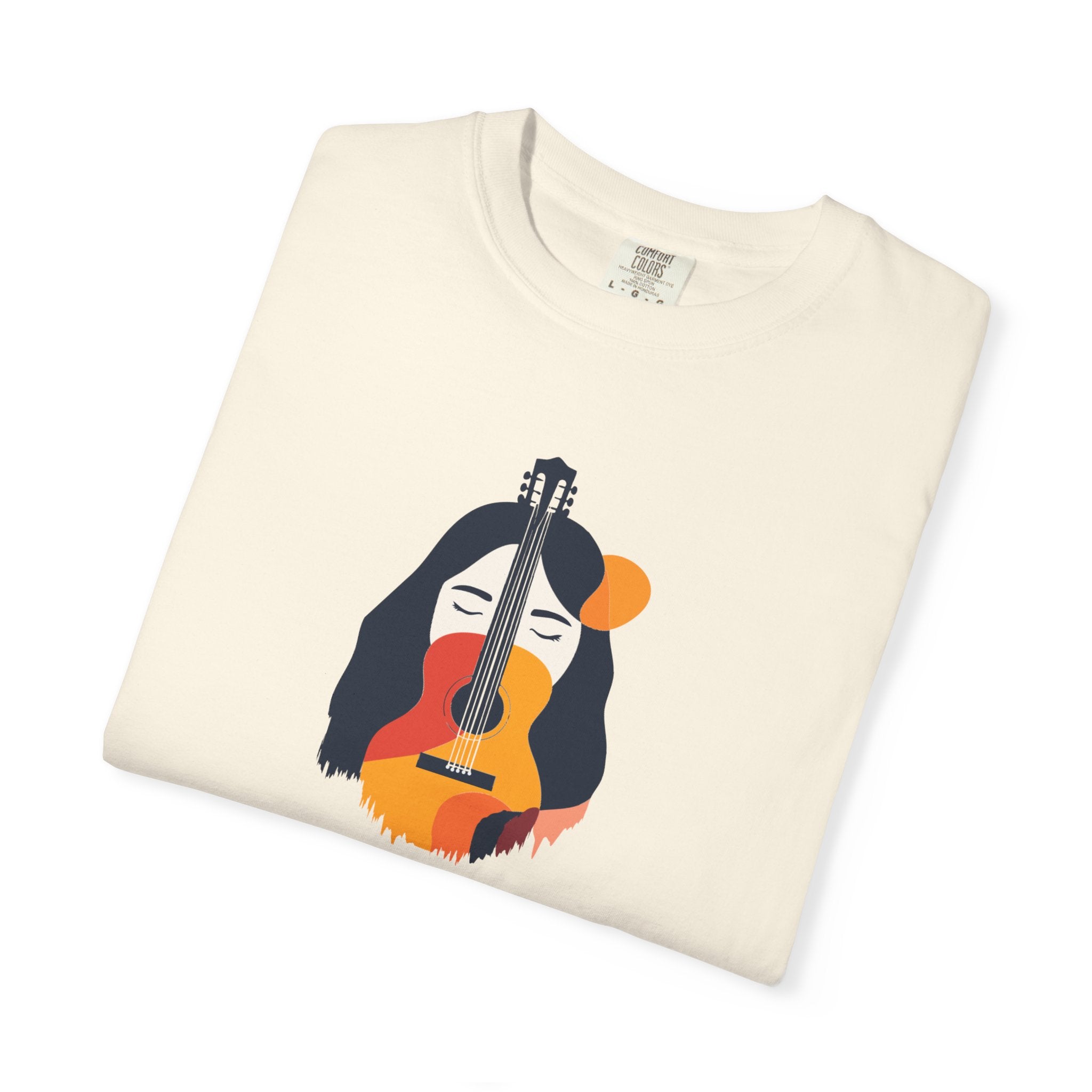 Folded cream-colored sweatshirt with a colorful graphic of a woman holding a guitar on a white background