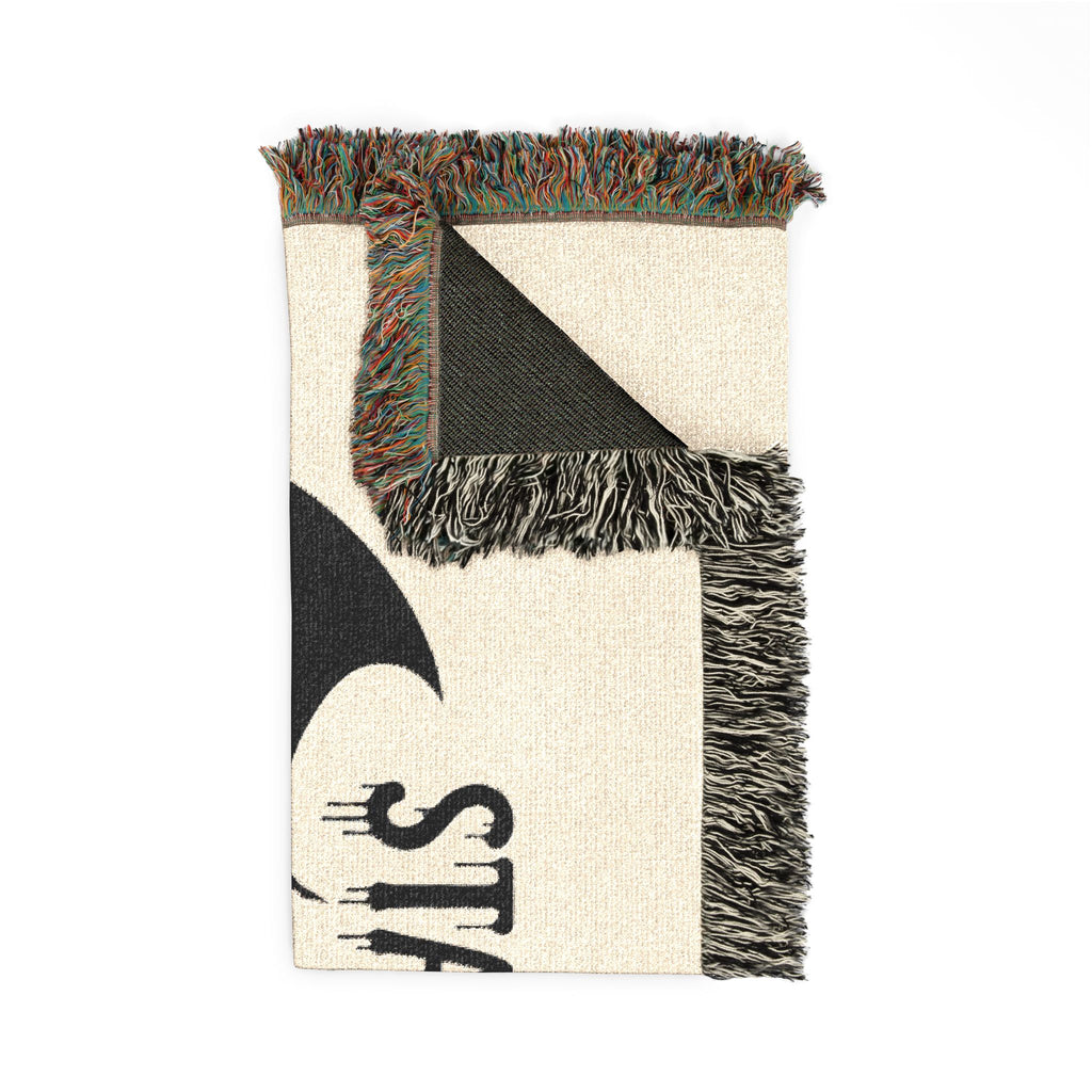 Textile with geometric pattern and fringes on a white background