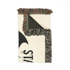 Textile with geometric pattern and fringes on a white background