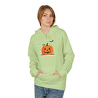 Person wearing a light green hoodie with a pumpkin design on a white background