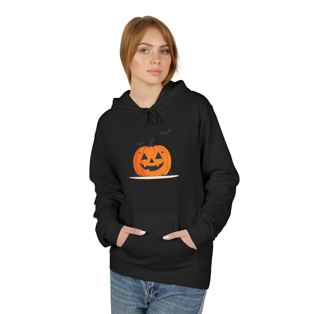 Person wearing a black hoodie with a pumpkin design on a white background
