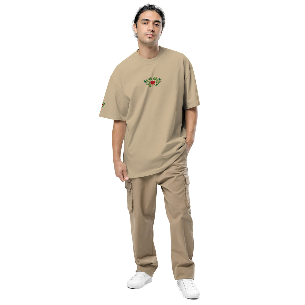 Man wearing a beige t-shirt and pants with a logo on a white background