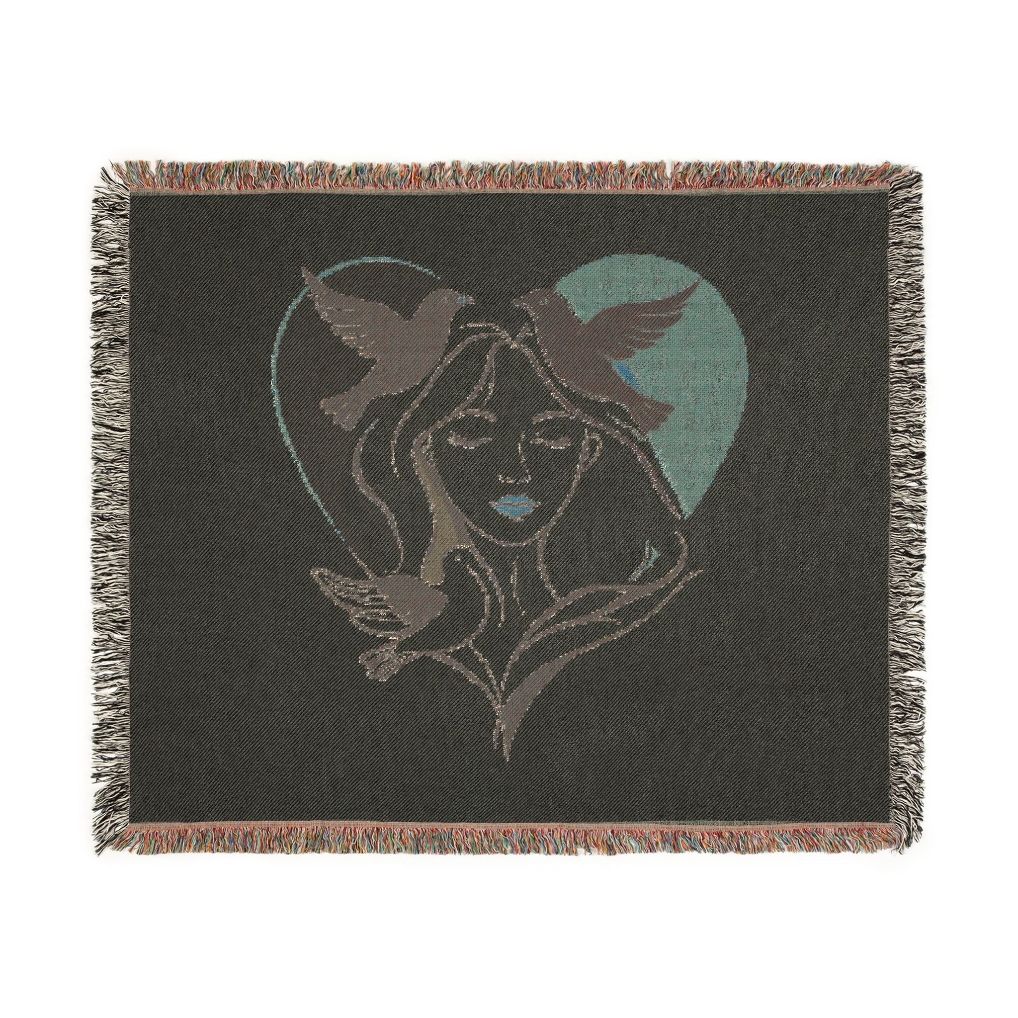 Blanket with a design of a woman's face and birds in a heart shape on a black background
