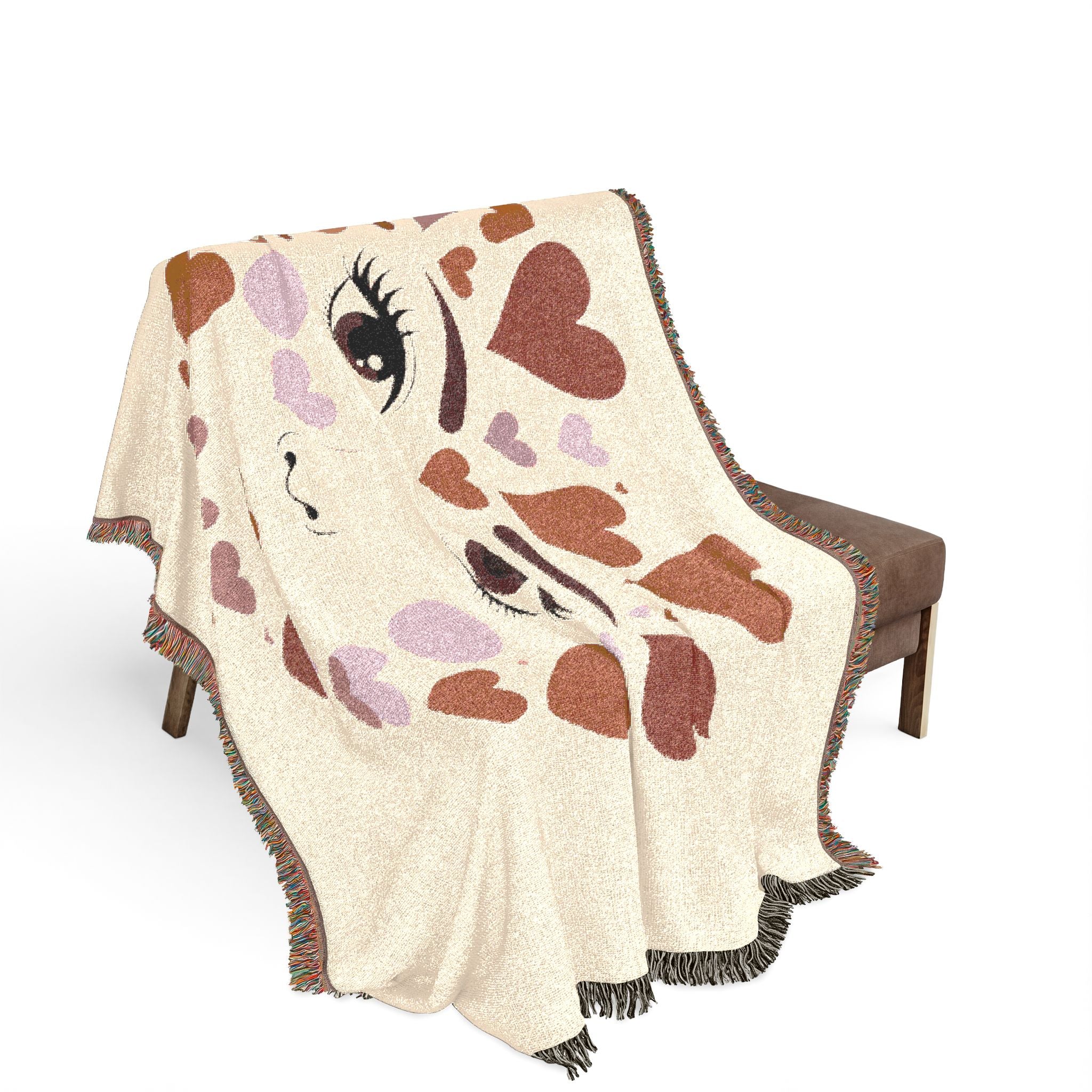 Blanket with a cartoon face design draped over a chair on a white background