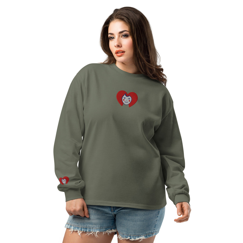 Woman wearing a green long-sleeve shirt with a heart design on a white background