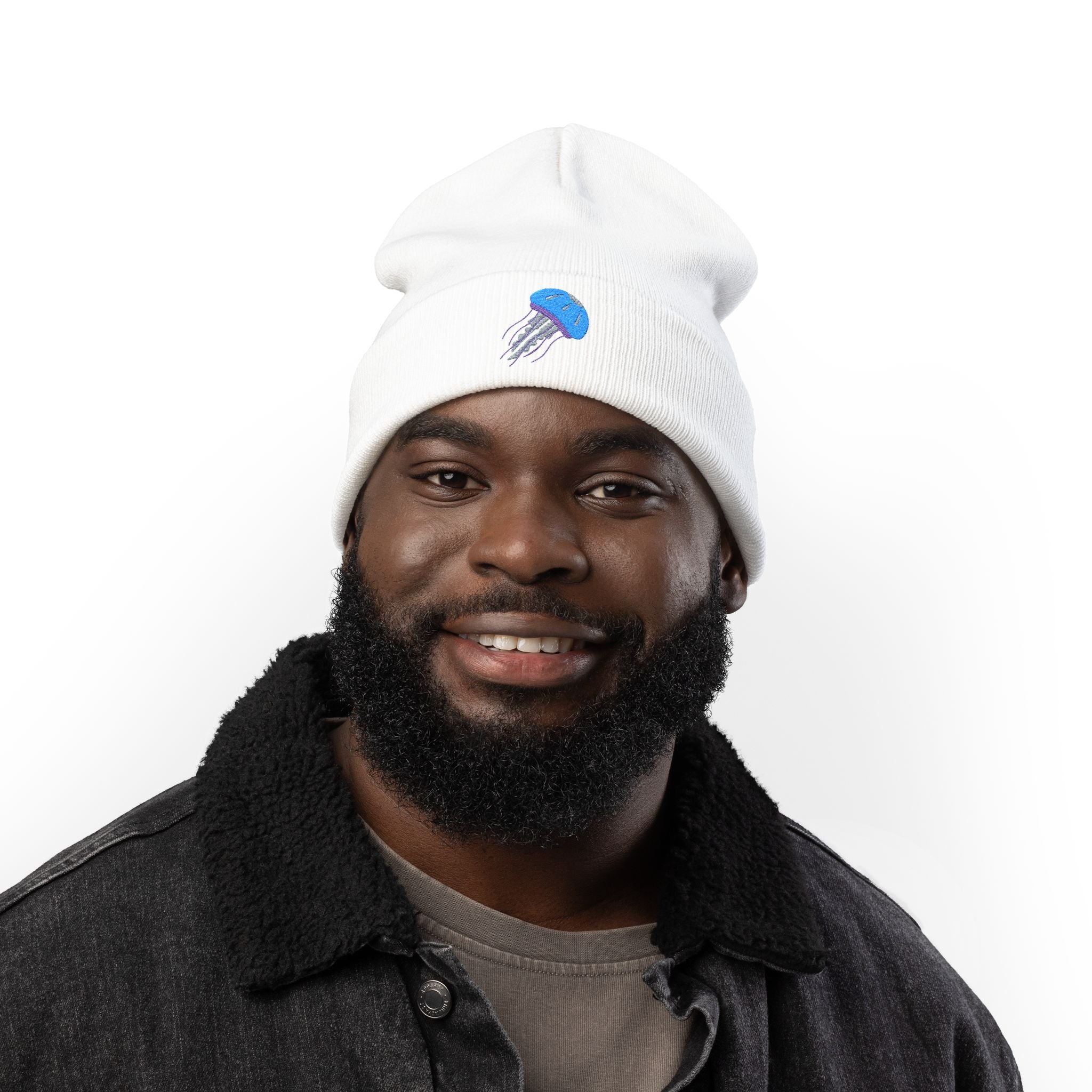 Man wearing a white beanie with a logo on a white background