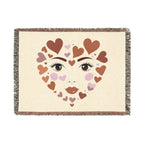 Blanket with heart-shaped face design on a beige background