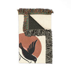 Decorative throw blanket with bird design on a white background
