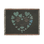 Blanket with a face design made of hearts on a dark background