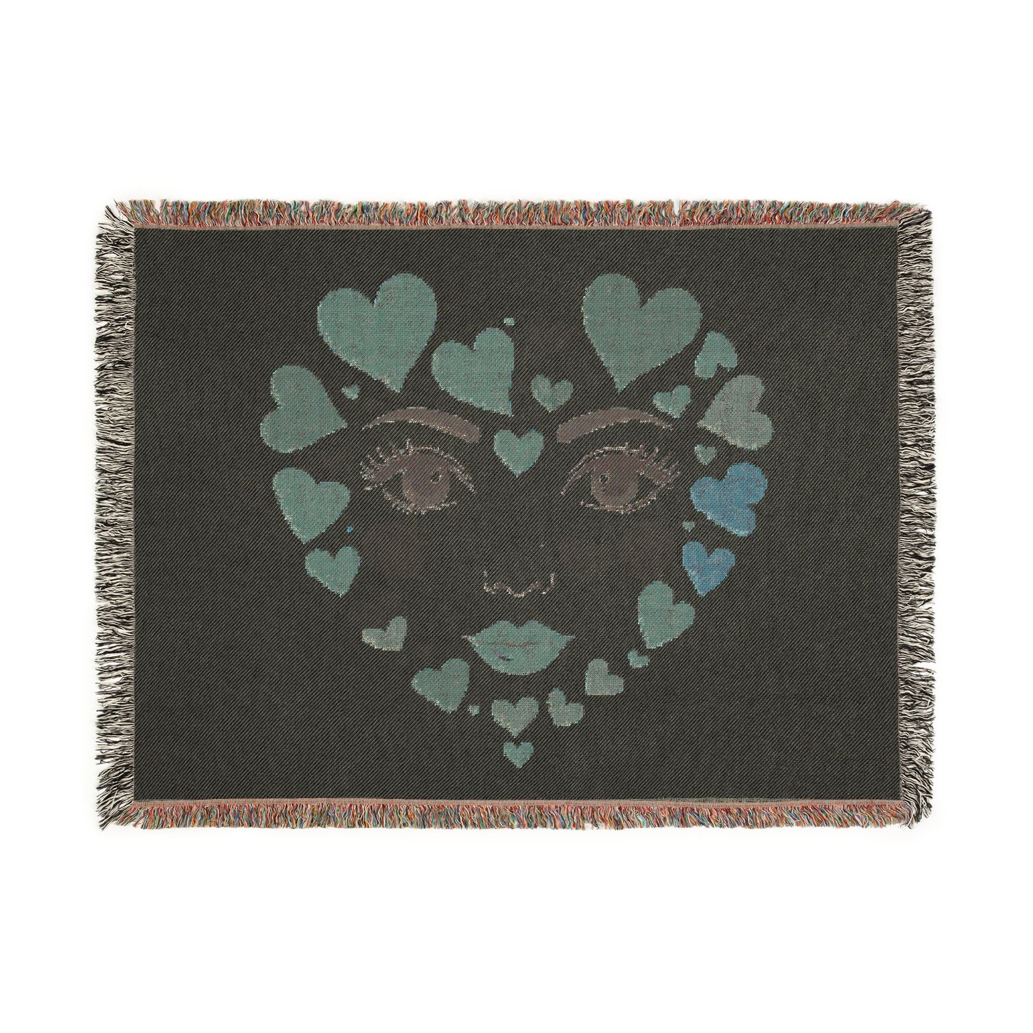 Blanket with a face design made of hearts on a dark background