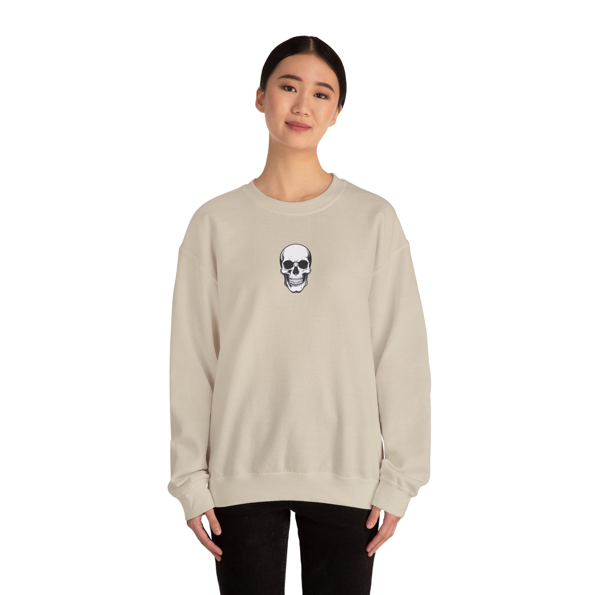 Person wearing a beige sweatshirt with a skull design on a white background