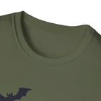 Close-up of a green t-shirt with a black bat logo on a white background