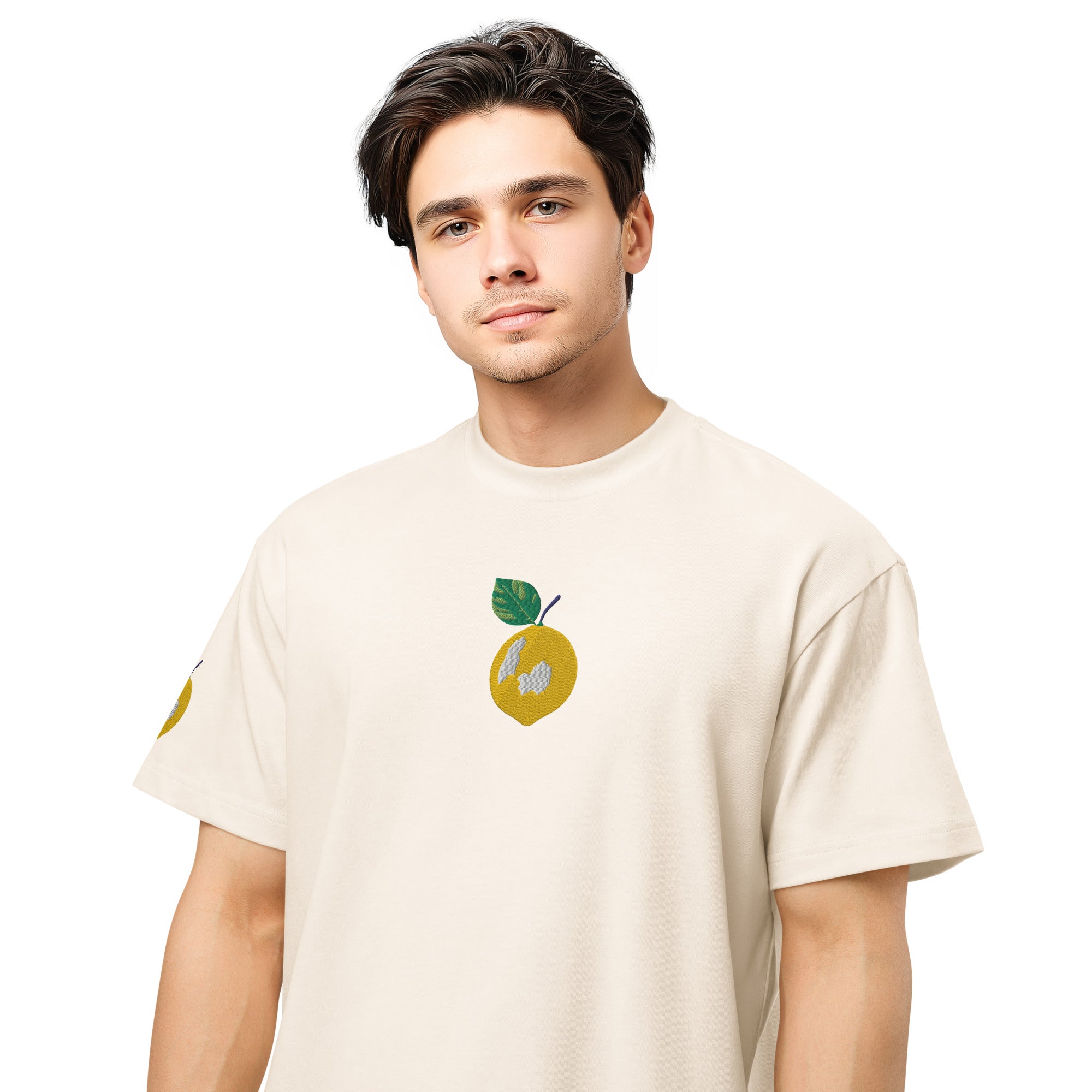 Man wearing a beige t-shirt with a graphic design on a white background