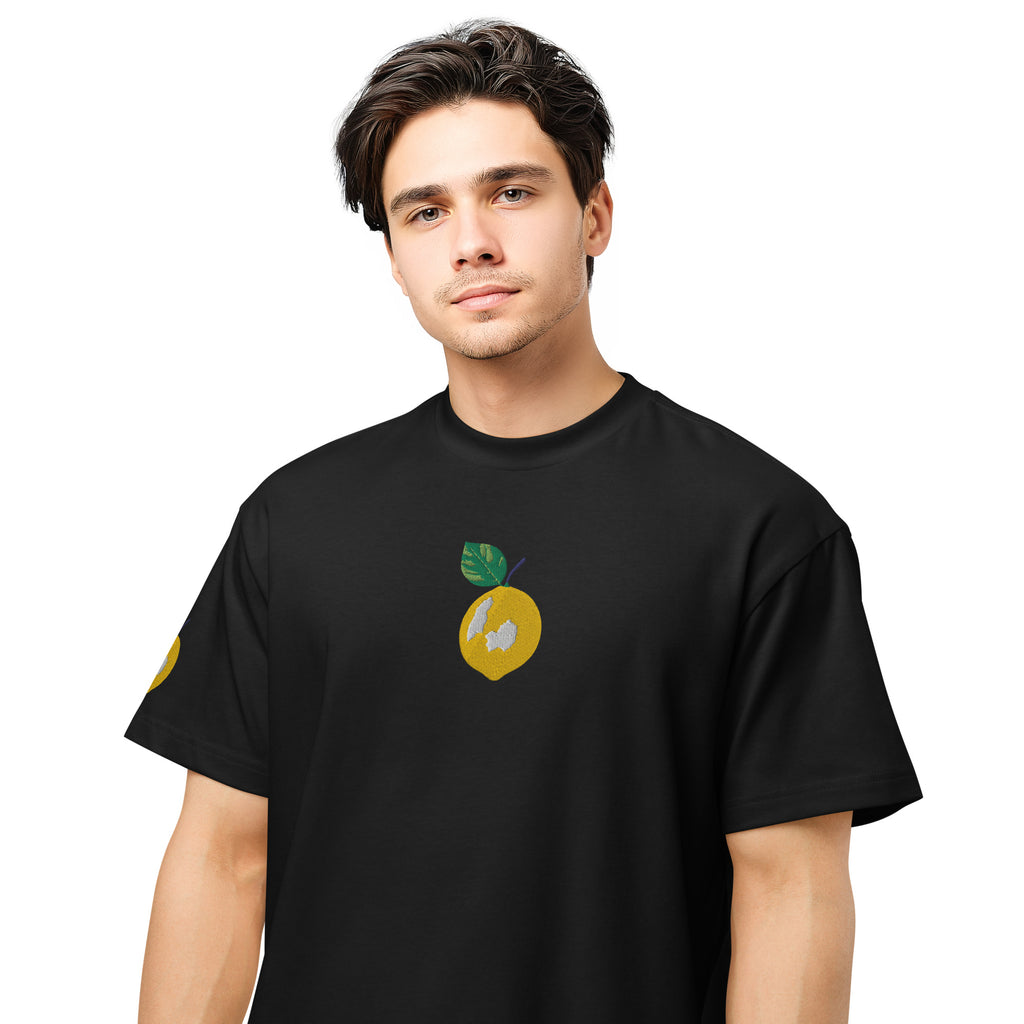 Person wearing a black t-shirt with a lemon graphic on a white background