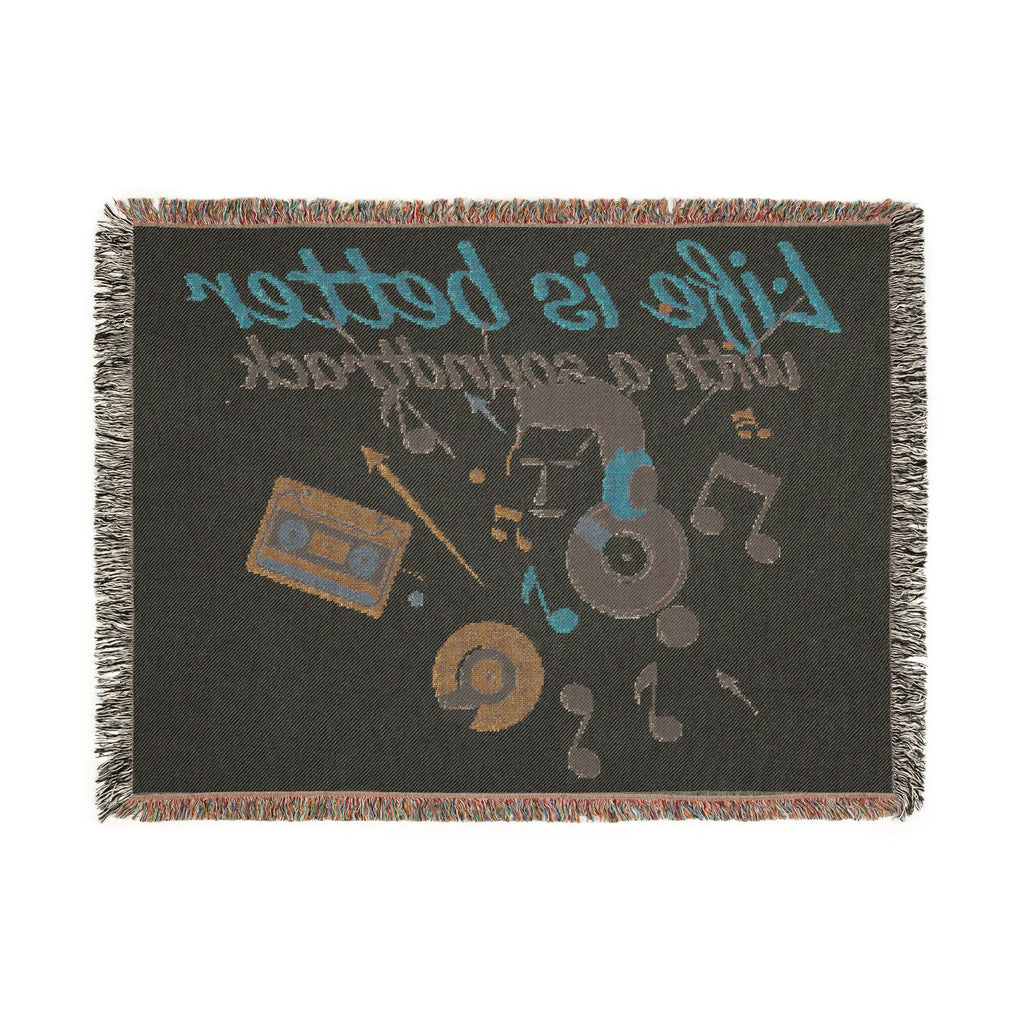 Woven blanket with music-themed design featuring cassette tape, vinyl record, and text on a black background.