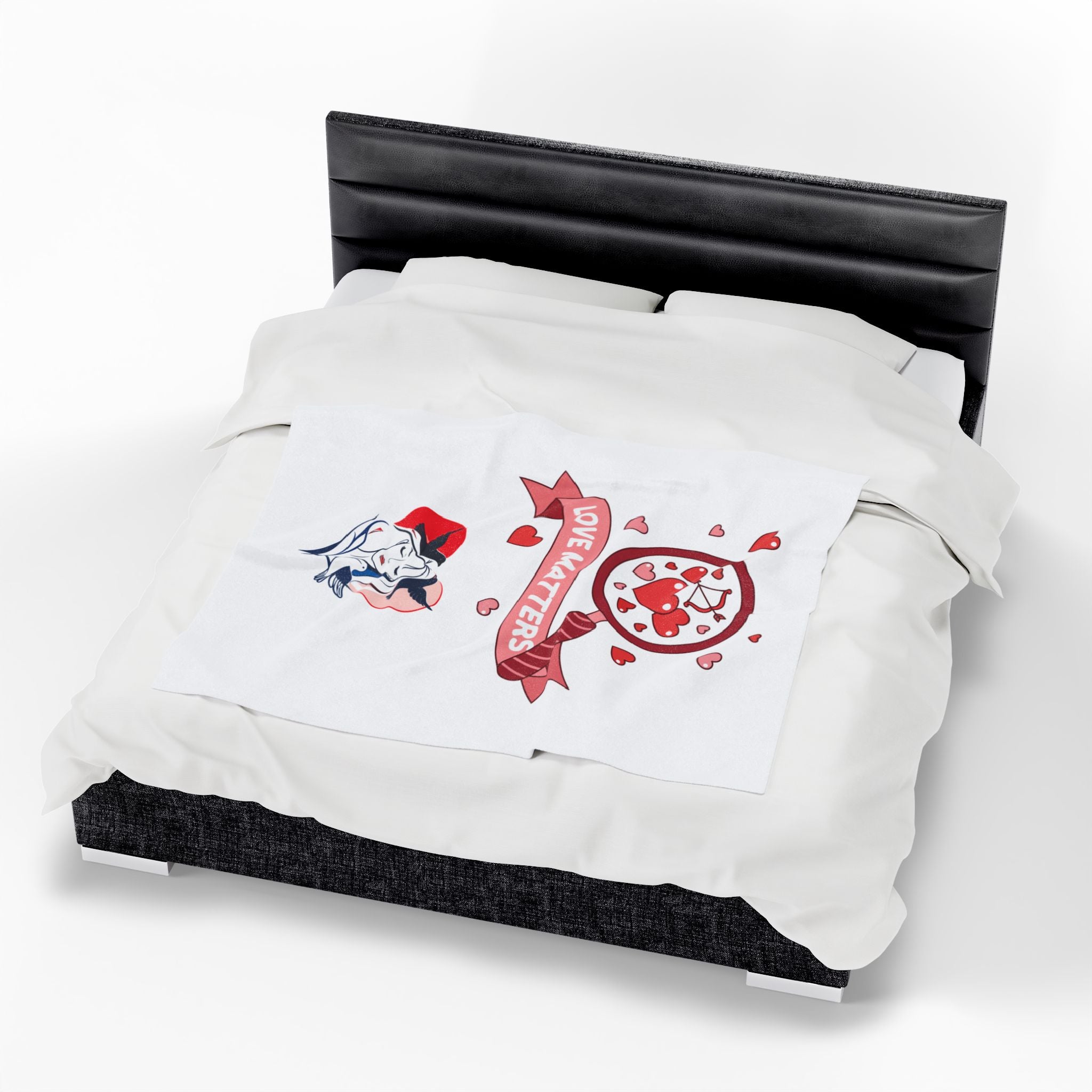 White comforter with red and black designs on a bed with a black headboard.