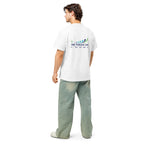 Man wearing a white t-shirt with a logo on the back, standing against a white background