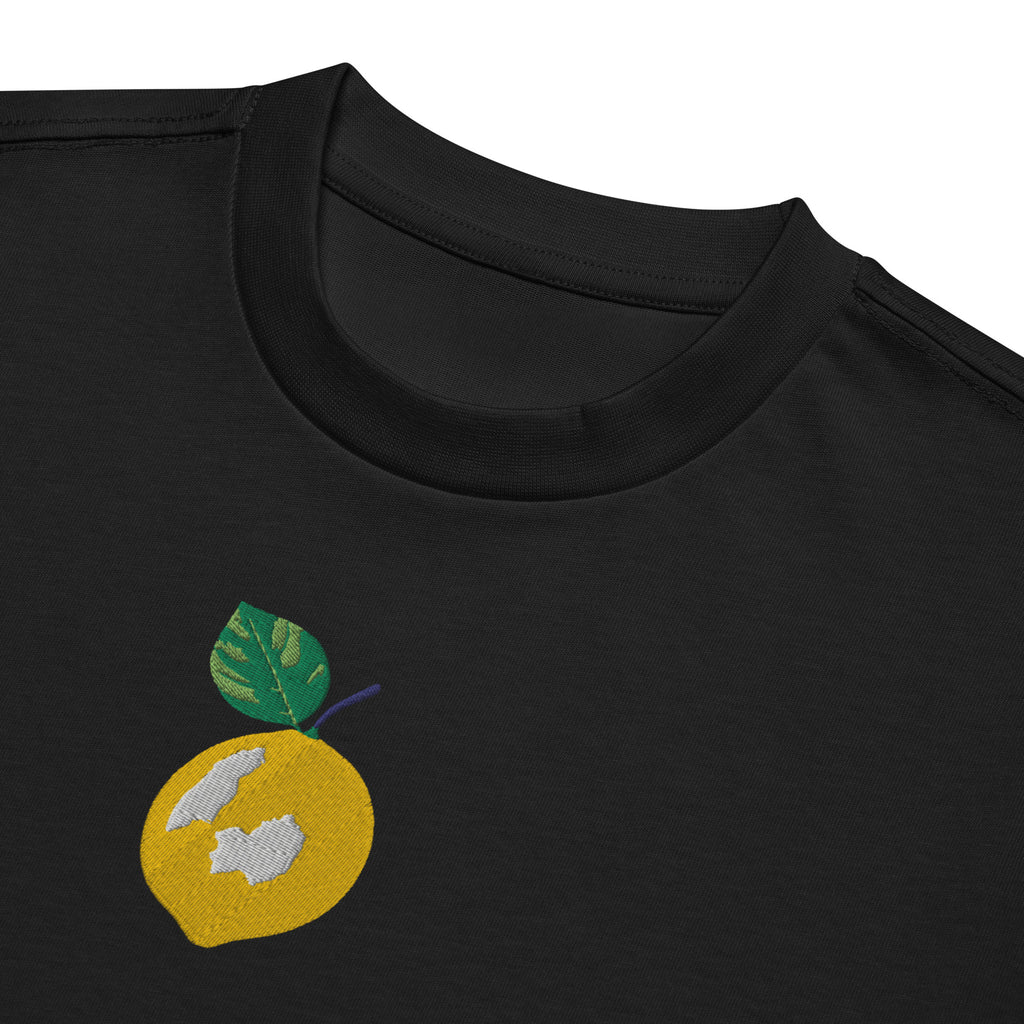 Black t-shirt with a yellow circle design featuring a leaf and abstract shapes on a white background