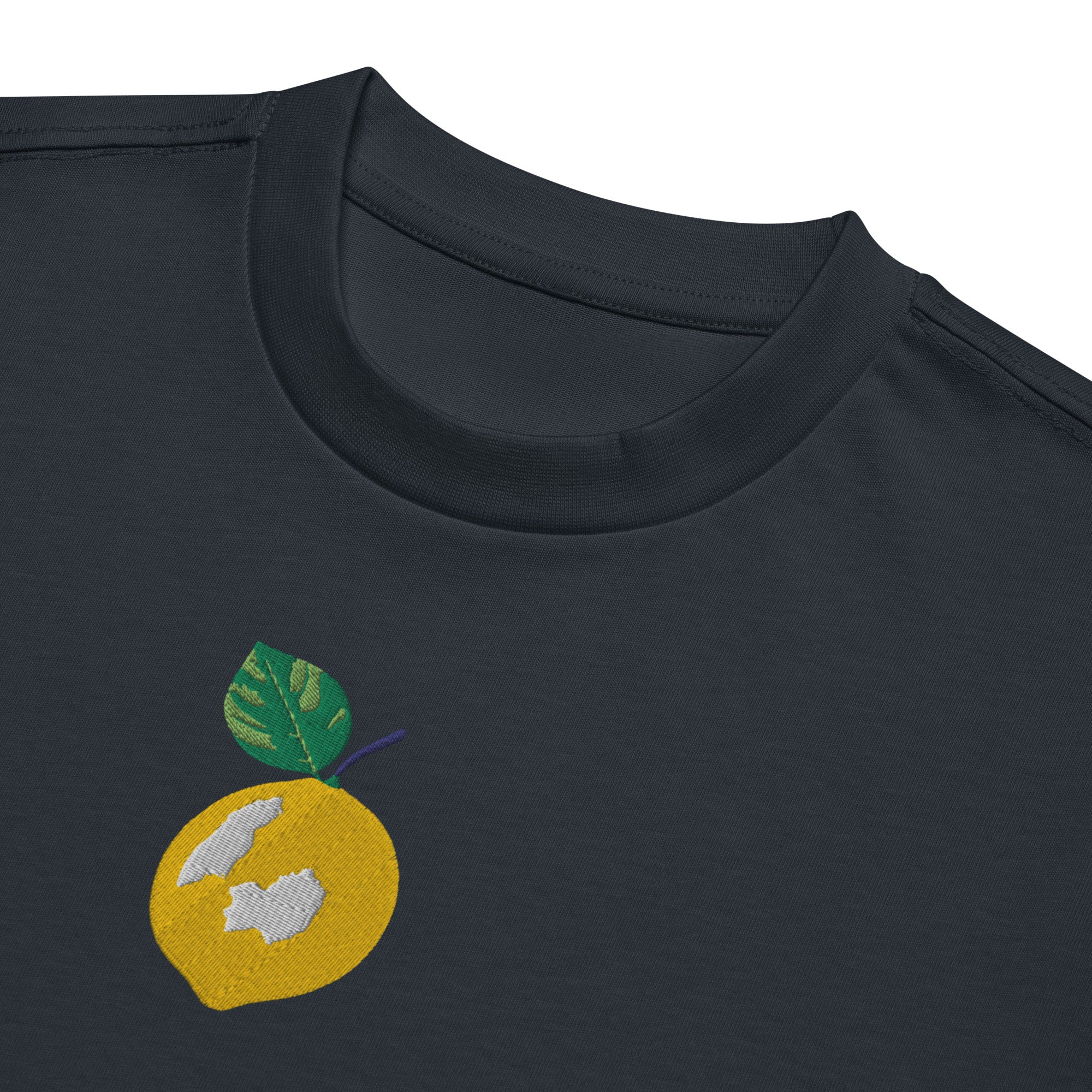Navy blue t-shirt with a yellow fruit design featuring a green leaf on a white background