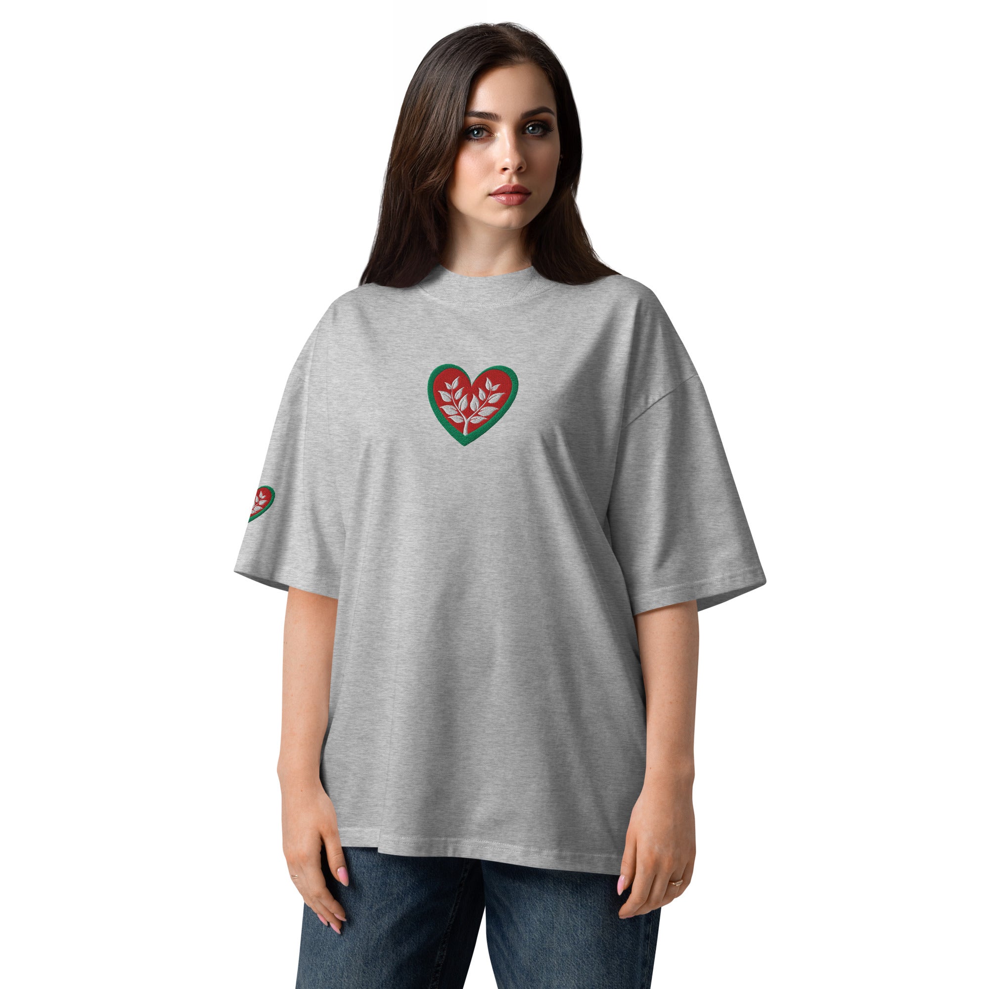 Woman wearing a gray t-shirt with a heart design on a white background