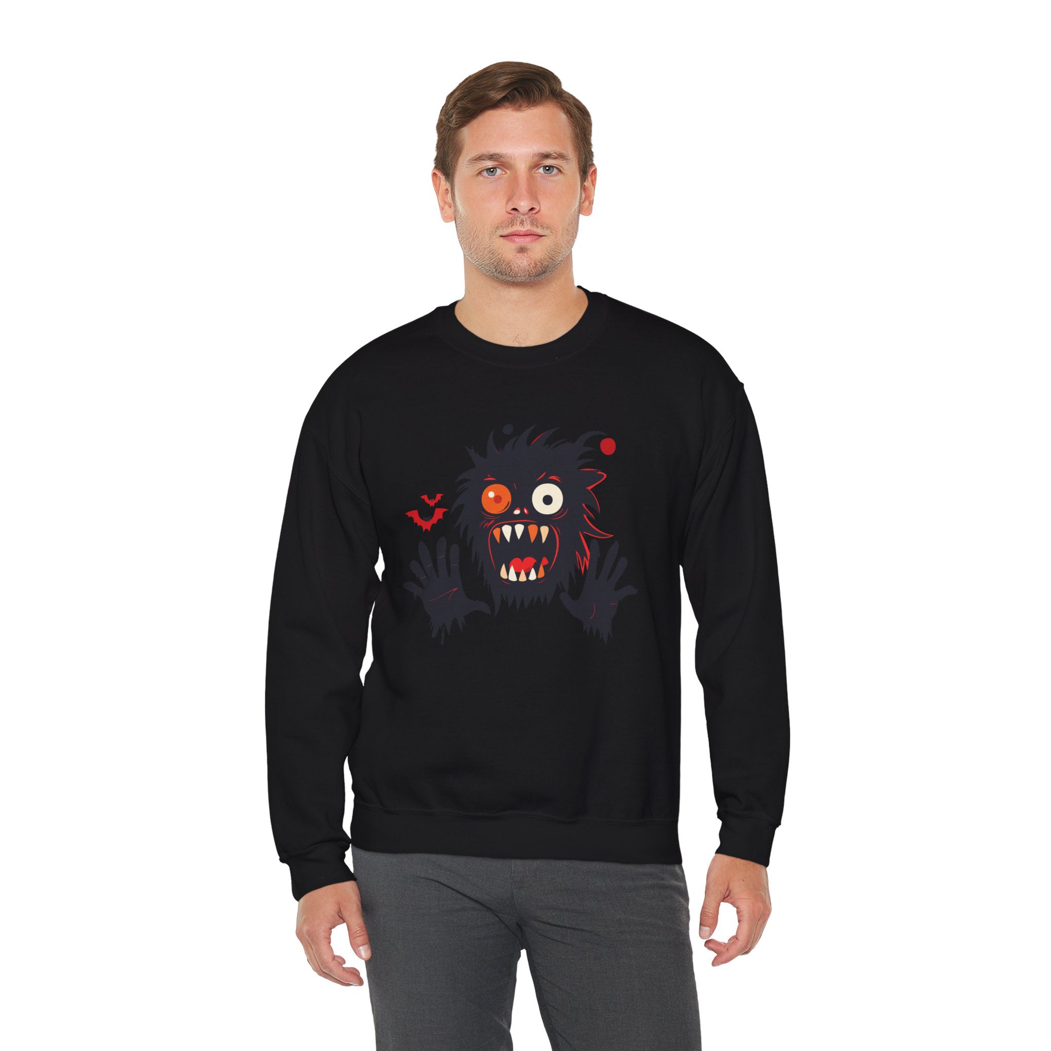 Person wearing a black sweatshirt with a cartoonish monster design on a white background
