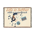 Blanket with music-themed design and 'Life is better with a soundtrack' text on a white background
