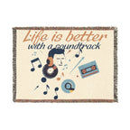 Blanket with music-themed design and 'Life is better with a soundtrack' text on a white background