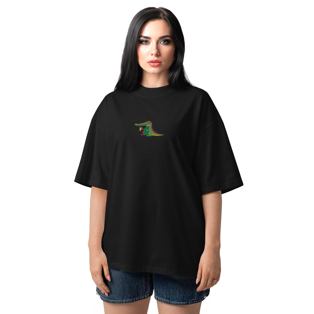 Woman wearing a black t-shirt with a colorful alligator design on a white background