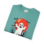 Folded teal t-shirt with Halloween design featuring a ghost, moon, and bats on a white background.