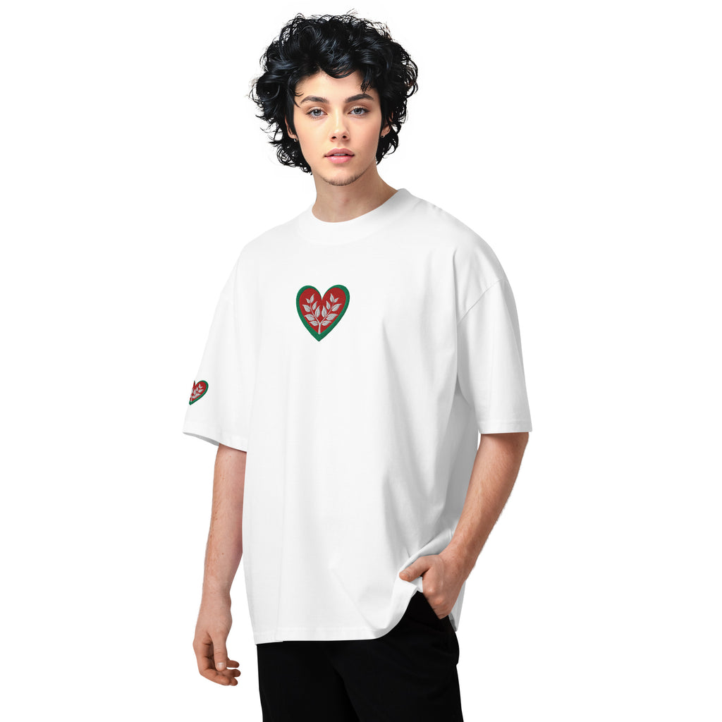 Person wearing a white t-shirt with a red and green heart design on a white background