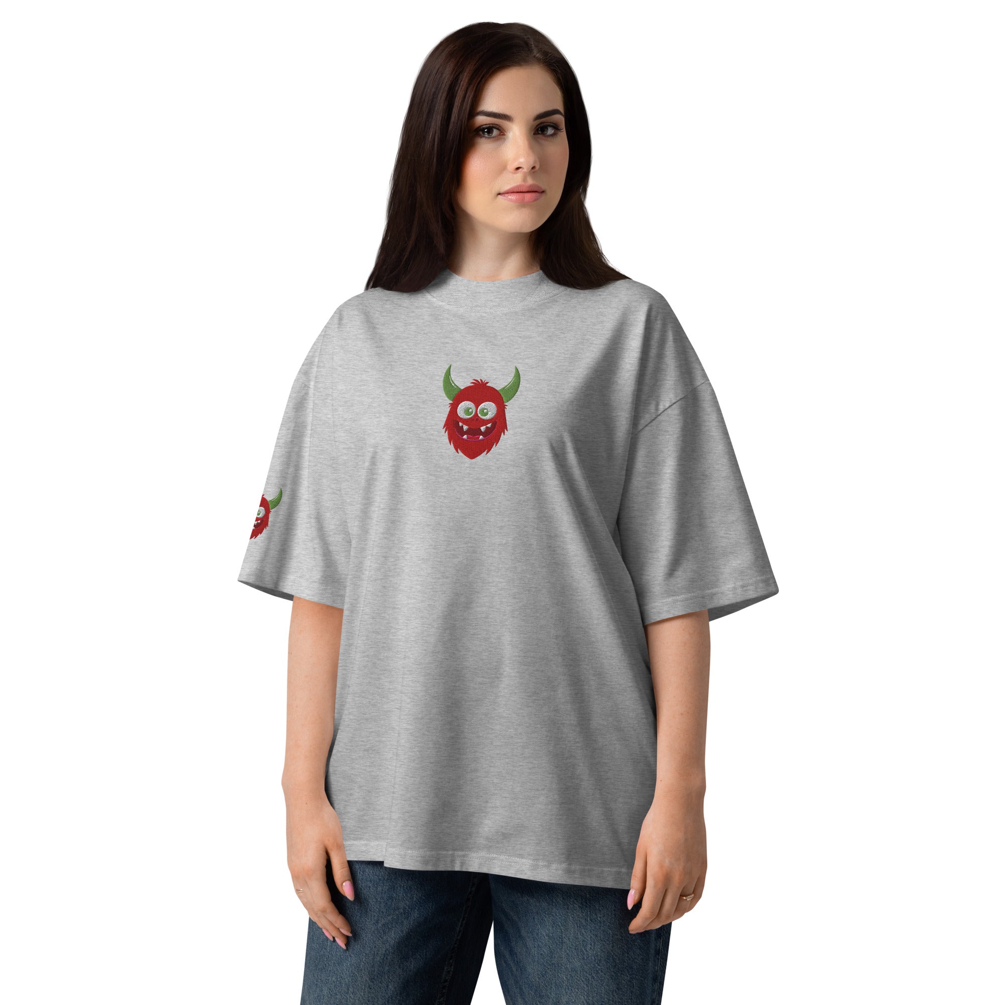 Woman wearing a gray t-shirt with a green and red design on a white background