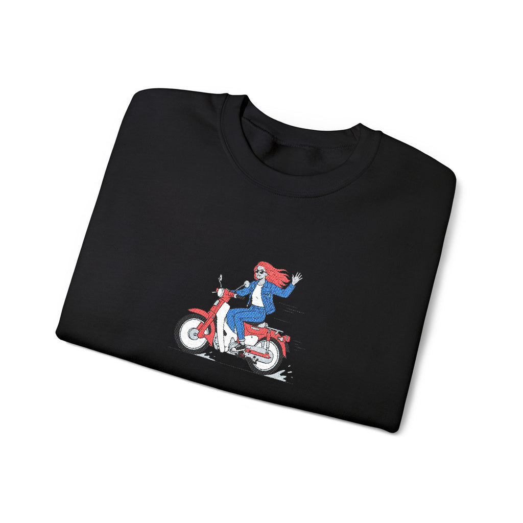 Folded black t-shirt with a graphic of a person on a motorcycle on a white background
