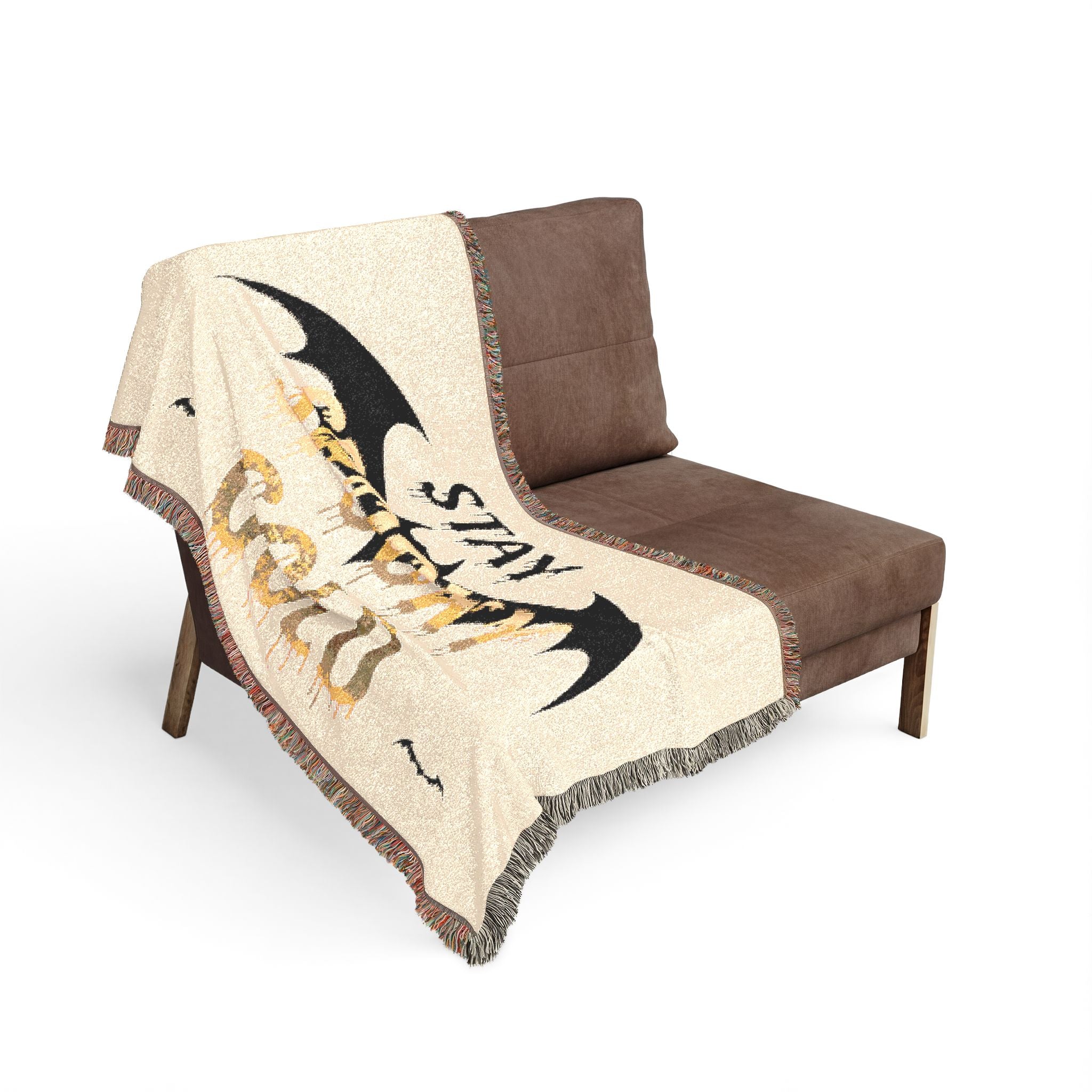 Brown chair with a decorative blanket featuring bat designs and text on a white background