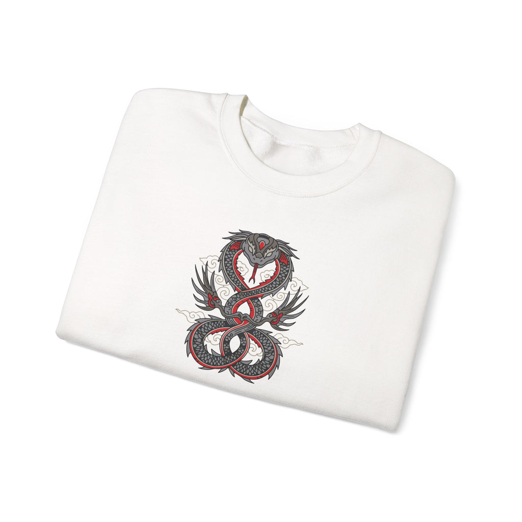 Folded white sweatshirt with a dragon design on a white background