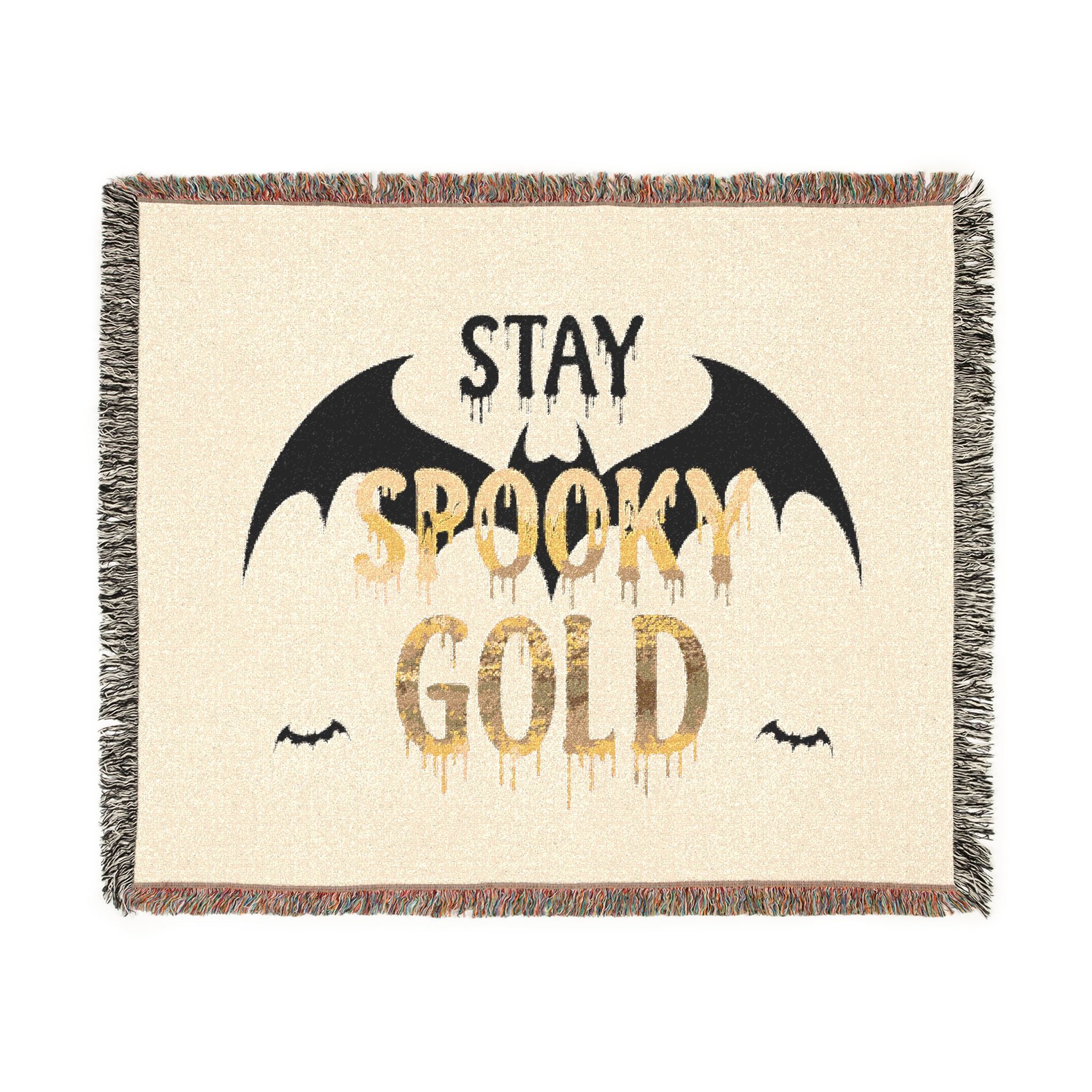 Blanket with 'Stay Spooky Gold' text and bat designs on a beige background