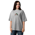 Woman wearing a gray t-shirt with a green and red design on a white background